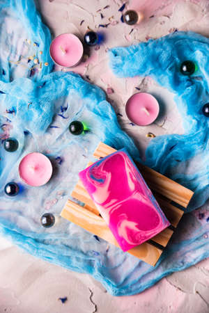 Romantic background with candles, soap and shawlの写真素材
