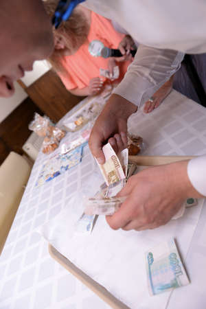 Male hands count money during weddingの写真素材