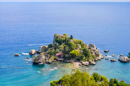 View of beach and island Isola Bella in Sicilyの写真素材