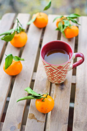 Close up tea mug with vitamin drink and tangerinesの写真素材