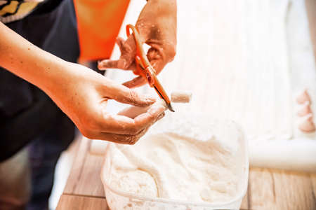 Woman hands cut white marshmallow