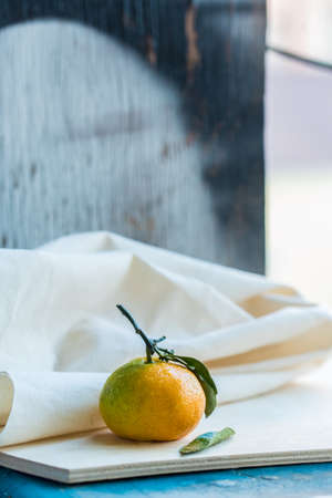 Close up fresh tangerine with leaf on whiteの写真素材