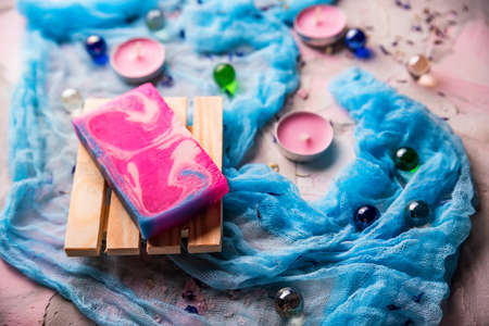 Romantic background with candles, soap and shawl