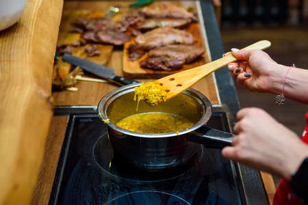 Cooking orange zest in saucepanの写真素材