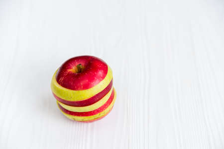 Mixed slices of red and green apple on white closeの写真素材