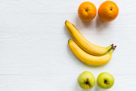 Fresh apples, oranges and bananas on white
