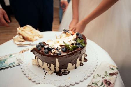 Bride and groom cut their wedding cakeの写真素材