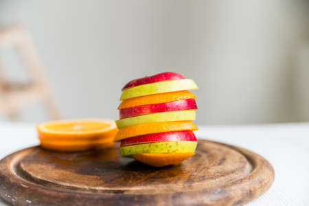 Mixed slices of orange, red and green appleの写真素材