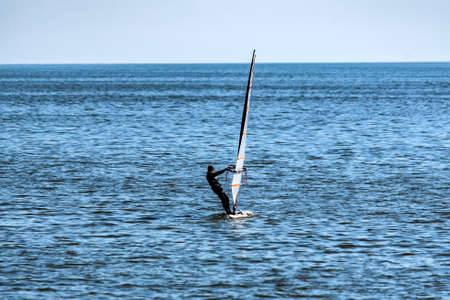 Lonely windsurfer in the seaの写真素材
