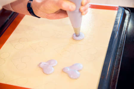 Making macarons with pastry bag