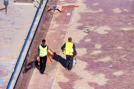 Workers pave sidewalkの写真素材
