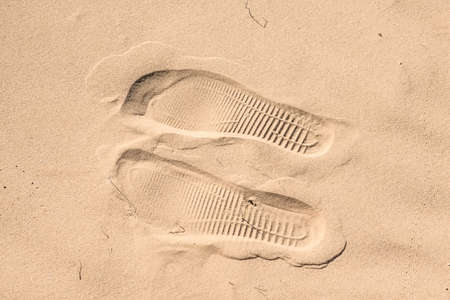Two shoe imprints on sand in desertの写真素材