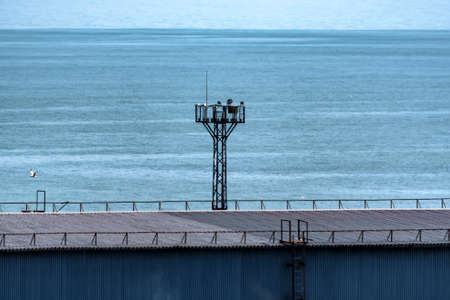 Industrial sea port with tall electric tower