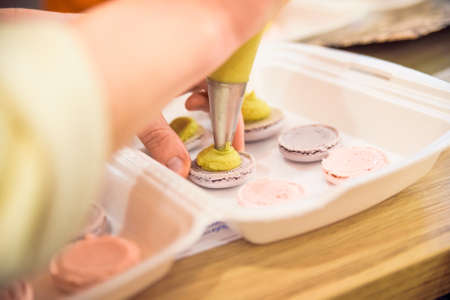 Making macarons with pastry bag close upの写真素材
