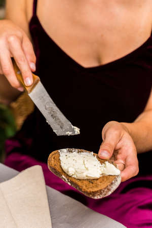 Female hands make sandwich of rye bread and cheeseの写真素材