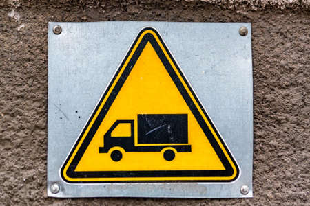 Close up yellow sign with image of truckの写真素材