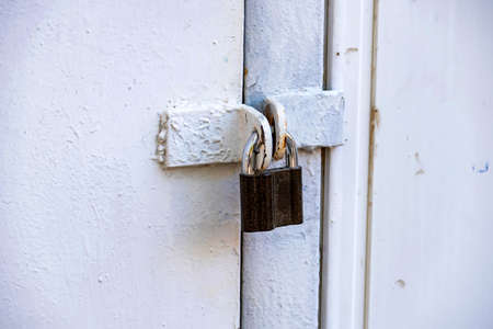 Old padlock on metal gate in black and whiteの写真素材