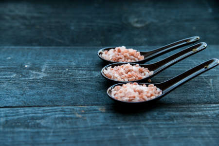 Studio shot of three spoons of pink himalayan saltの写真素材