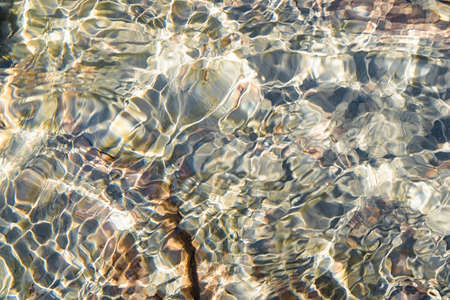 Close up of clear water of mountain river with underwater stones