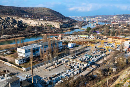 Industrial zone of a city near a river with building equipmentの写真素材