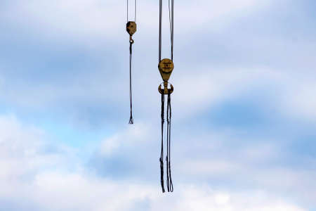 Close up shot of a crane at a harbour against skyの写真素材