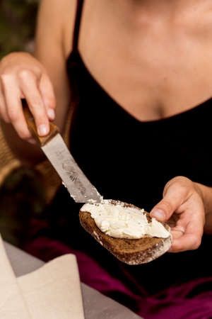 Female hands make sandwich of rye bread and cheeseの写真素材
