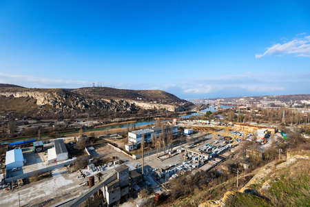Industrial zone of a city near a river with building equipmentの写真素材