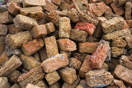 Close up heap of brown shellstone blocks used for buildingの写真素材