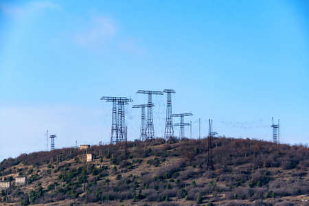 Hill with a lot of power towers at electric power stationの写真素材