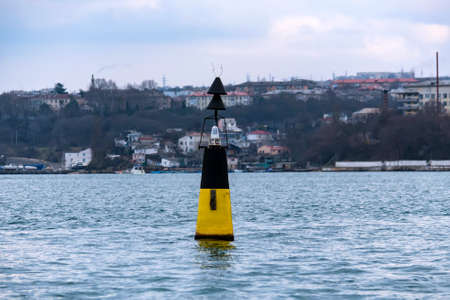 Close view of black and yellow beacon in Black seaの写真素材
