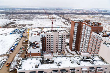 Distant view of a construction site with new buildings in winterの写真素材