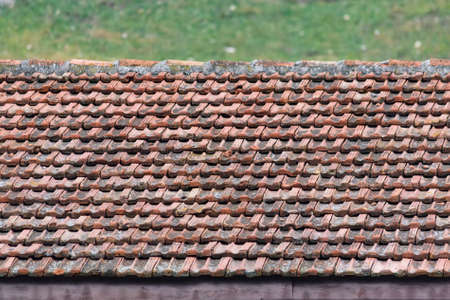 Close-up image of weathered brown tiles on roofの写真素材