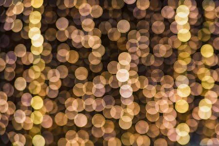 Abstract yellow holiday lights blur for festive backgroundの写真素材
