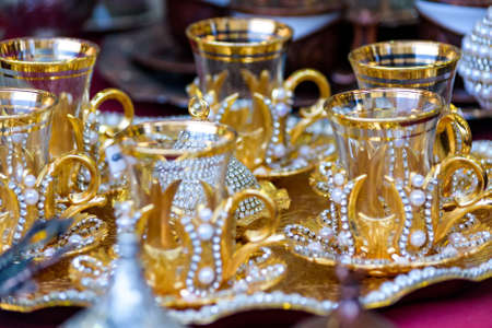 Golden color tea set for sale in street market closeの写真素材