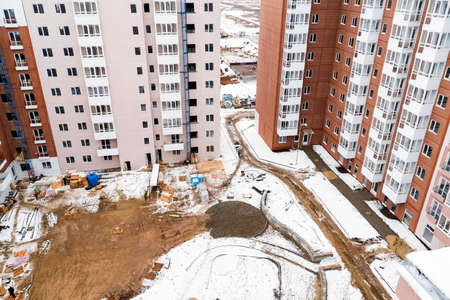 Top view snowy construction site with new appartment buildingの写真素材