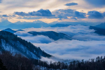 Beautiful distant winter mountains and skyscape with mistの写真素材