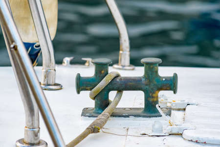Close up of boat rope tied to nautical cleat hitch on boatの写真素材