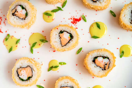 Sushi rolls scattered on white background close upの写真素材