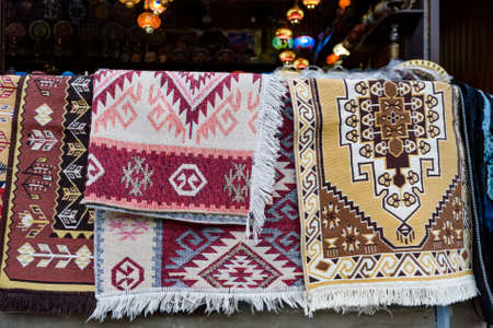 Hand made carpets hanging in street market