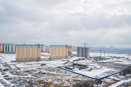 Distant view of a construction site with new buildings in winterの写真素材
