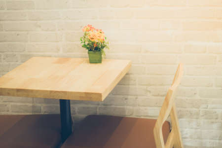 Table and chairs with vases in a cafeの写真素材