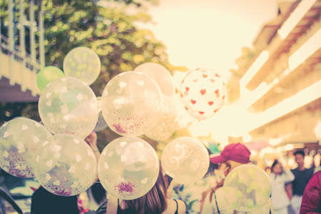 people walking street and has balloonsの写真素材