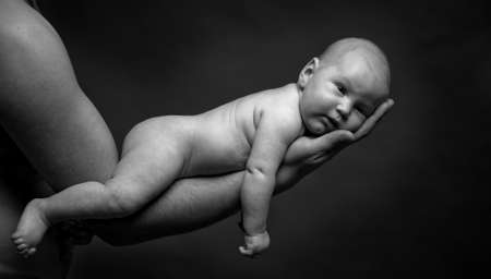 baby on father's strong handの写真素材