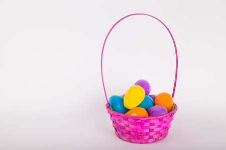 Easter egg basket with colorful plastic Easter eggsの写真素材