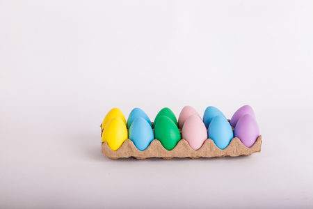 Easter eggs in a carton painted pastel colorsの写真素材