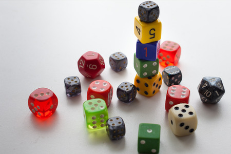 Close up gaming dice stacked and randomly placed on solid backgroundの写真素材