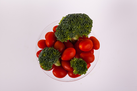 Overview cherry tomatoes broccoli florets in martini glassの写真素材
