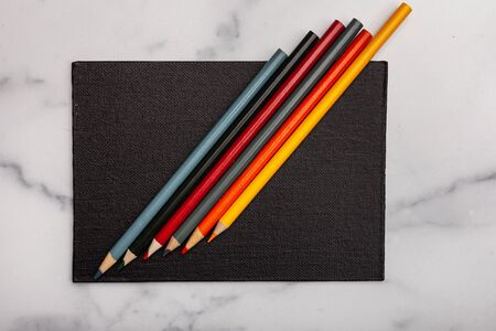 Black canvas with coloring pencils background texture