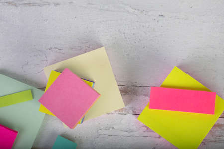Flat lay background with assorted colorful sticky notes blank and empty ready to add words
