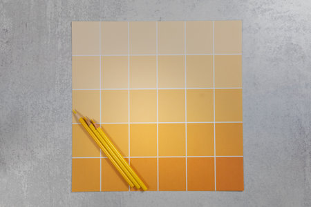 Light and dark shades of yellow on a color wheel chart card flat lay backgroundの写真素材